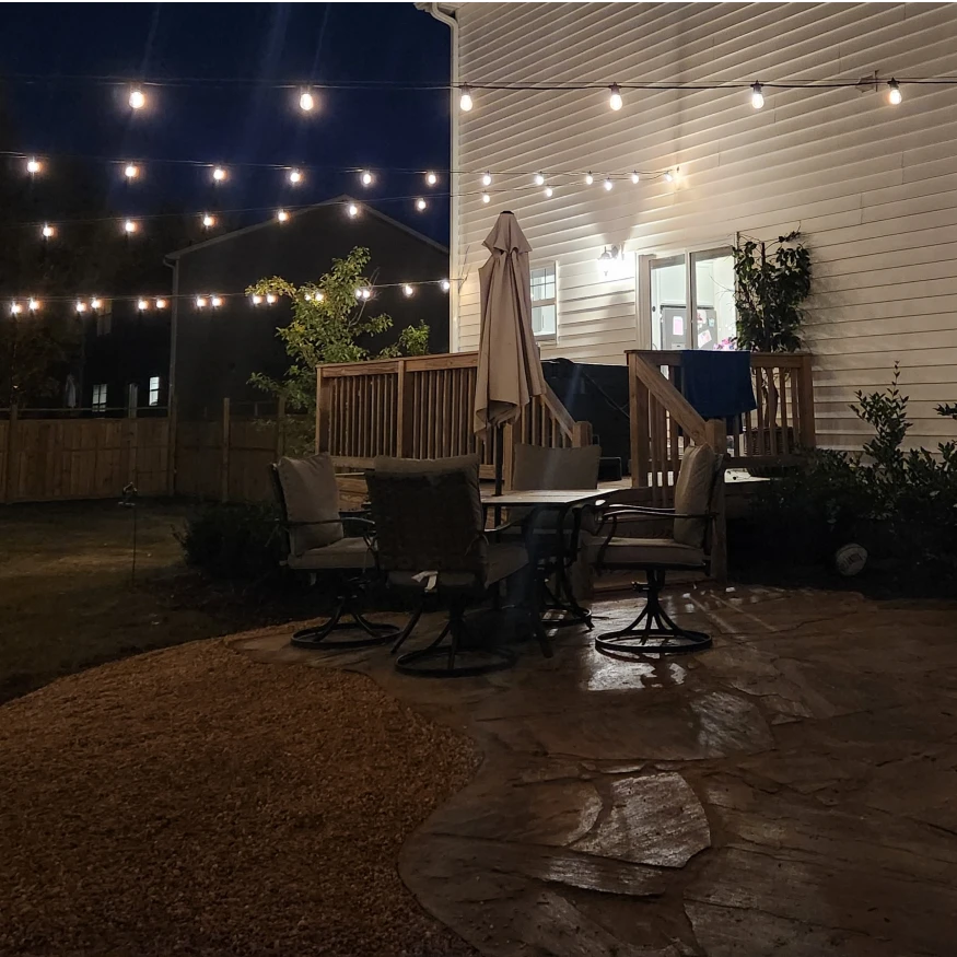 Natural stone patio and bistro lights. 