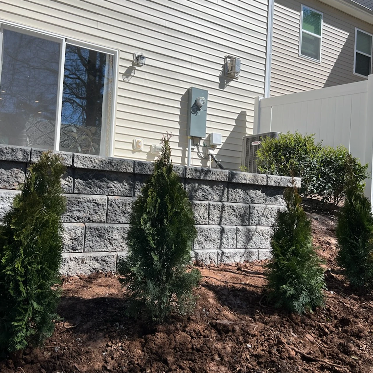 Block retaining wall with patio stablizied by foam. 